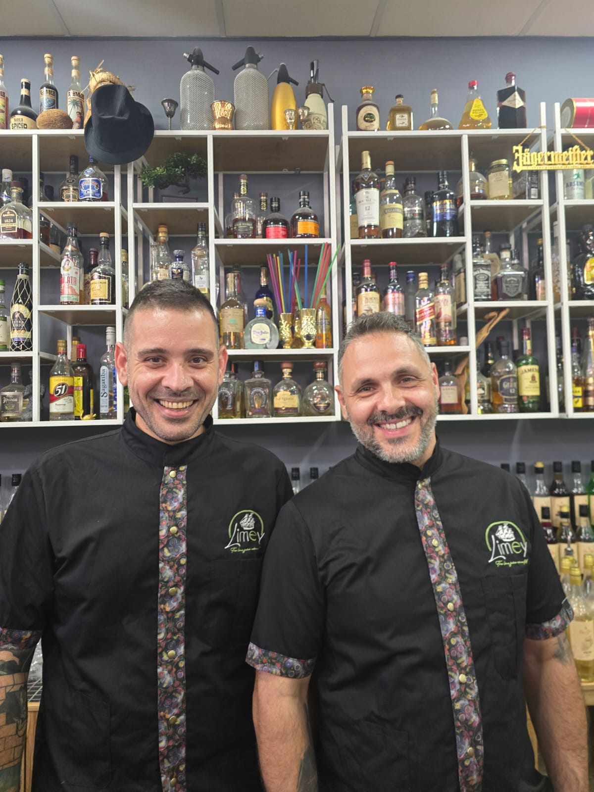 Giorgos Vourliotis and Jimmy Patsouras behind the bar in their Limey shirts